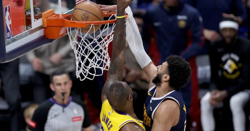 Jamal Murray of the Denver Nuggets dunks on LeBron James of the Los Angeles Lakers in the fourth quarter at Ball Arena in Denver on Monday night.