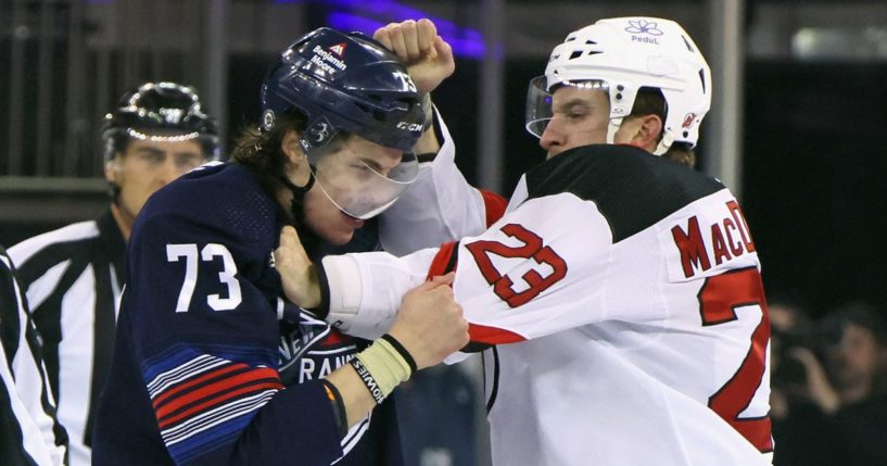 Kurtis MacDermid of the New Jersey Devils fights with Matt Rempe of the New York Rangers at the start of a game at Madison Square Garden in New York City on Wednesday.