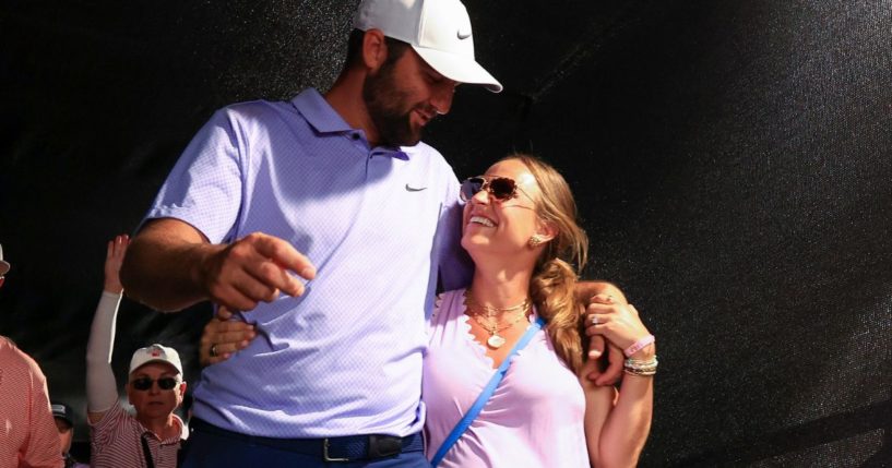 Scottie Scheffler, left, and Meredith Scheffler, right, walk to the clubhouse after winning the Arnold Palmer Invitational in Orlando, Florida, on March 10.