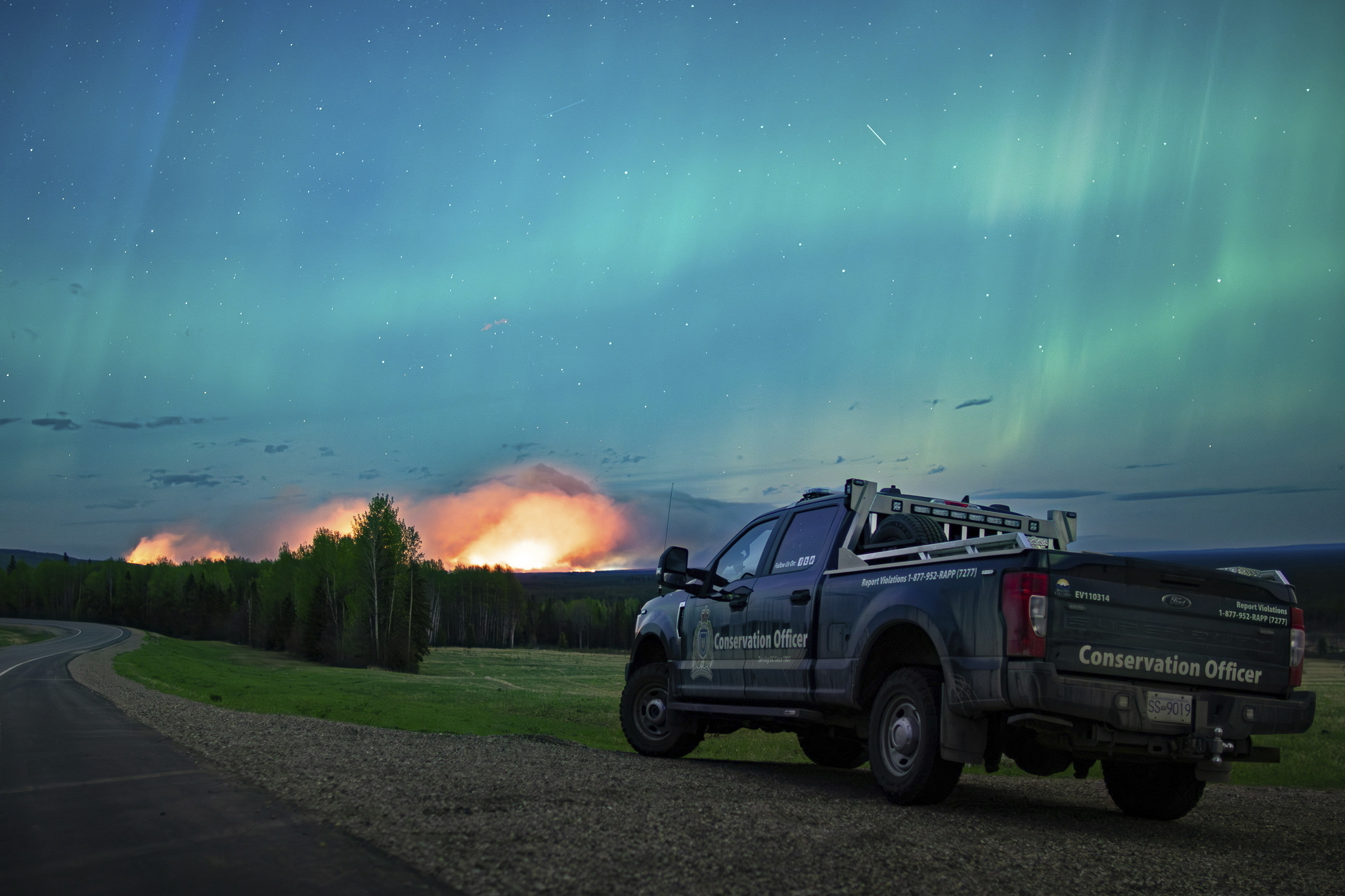 An Aurora Borealis is pictured near Fort Nelson, British Columbia, on Saturday. An intense wildfire could hit a town in western Canada on Monday, based on forecasts of strong winds that have been fueling the out-of-control blaze which has already forced the evacuation of thousands, fire experts and officials warned.