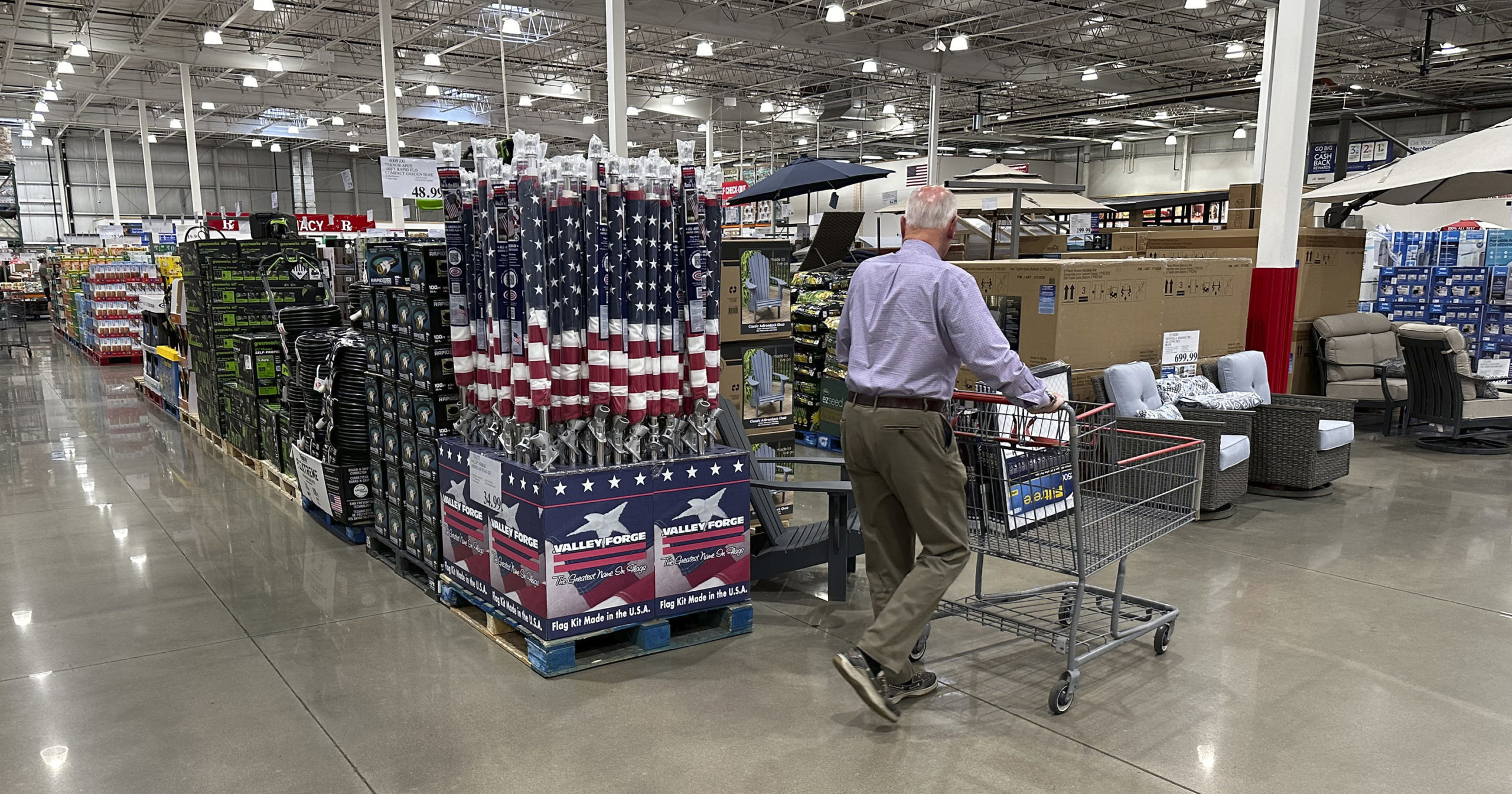 A shopper moves past a display of items in a Costco warehouse on May 18, 2024, in Sheridan, Colorado. As many Americans celebrate Memorial Day on Monday, May 27, 2024, there are several stores, government offices and businesses that will be open.