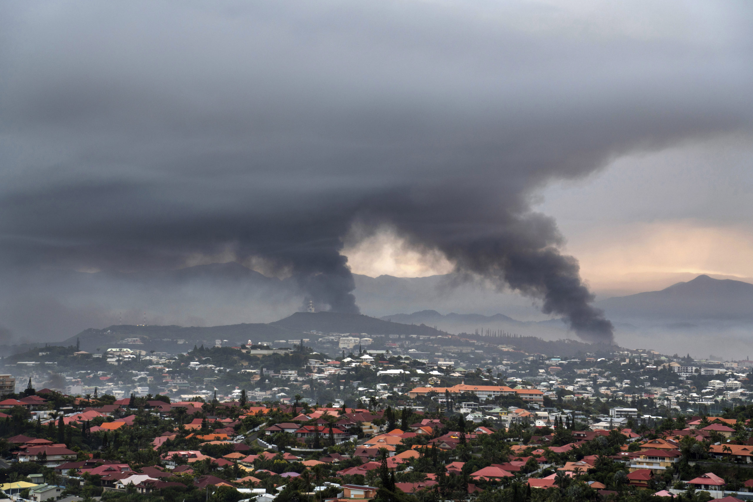 Smoke rises during armed clashes in Noumea, New Caledonia, on Wednesday. France has imposed a state of emergency in the French Pacific territory.