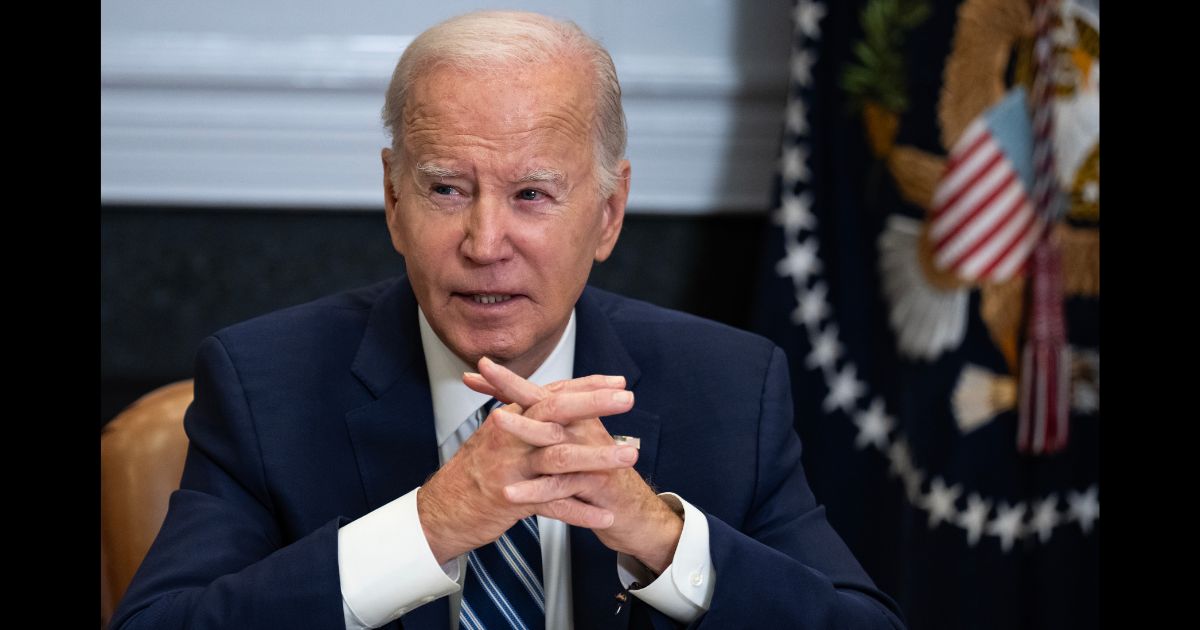 President Joe Biden sits with clasped hands during a meeting about the ongoing fentanyl crisis in the Roosevelt Room of the White House in 2023.