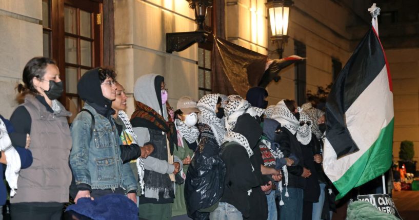 Anti-Israel protesters lock arms at the entrance to Hamilton Hall on the campus of Columbia University in New York City on Tuesday.