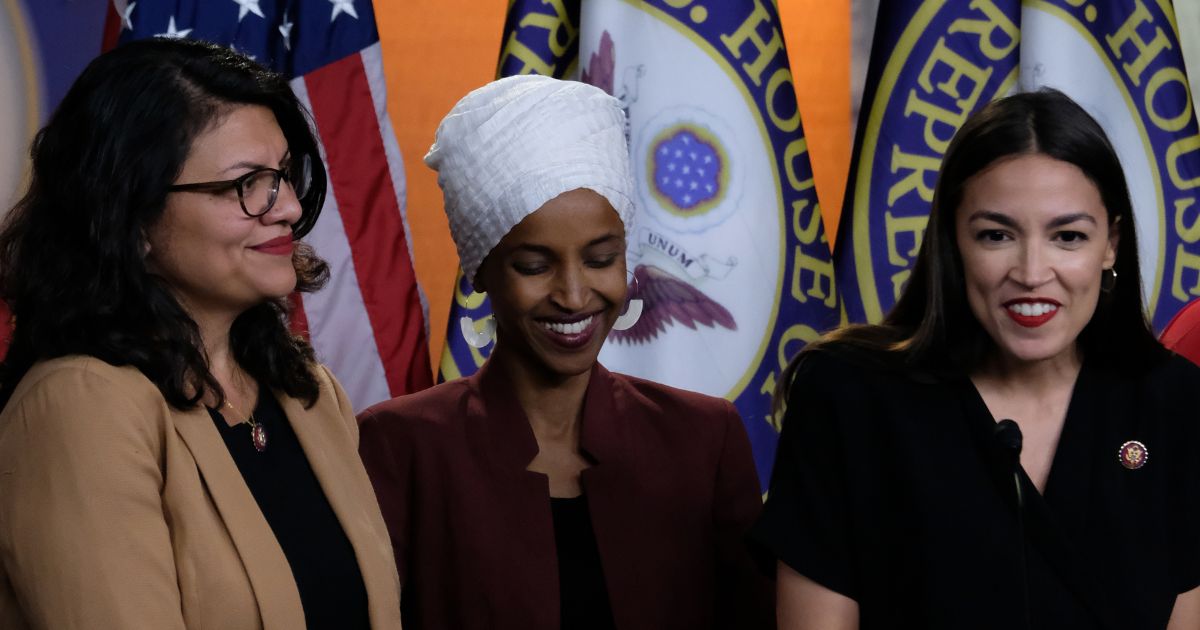 Reps. Rashida Tlaib, left; Ilhan Omar, center; and Alexandria Ocasio-Cortez, right, listen during a news conference at the U.S. Capitol in Washington, D.C., on July 15, 2019.