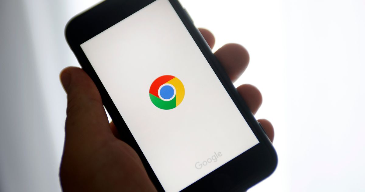 A photo illustration shows the Google Chrome logo displayed on the screen of an iPhone in Paris on June 8, 2023.
