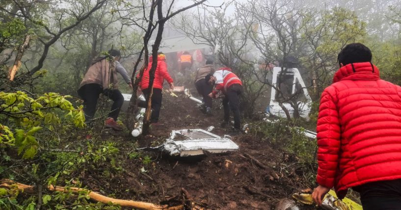 Iranian rescue teams recover the bodies from the crash site of the Iranian presidential helicopter in the dense forest of Dizmar between the cities of Varzaqan and Jolfa in East Azerbaijan province, Iran on Monday.