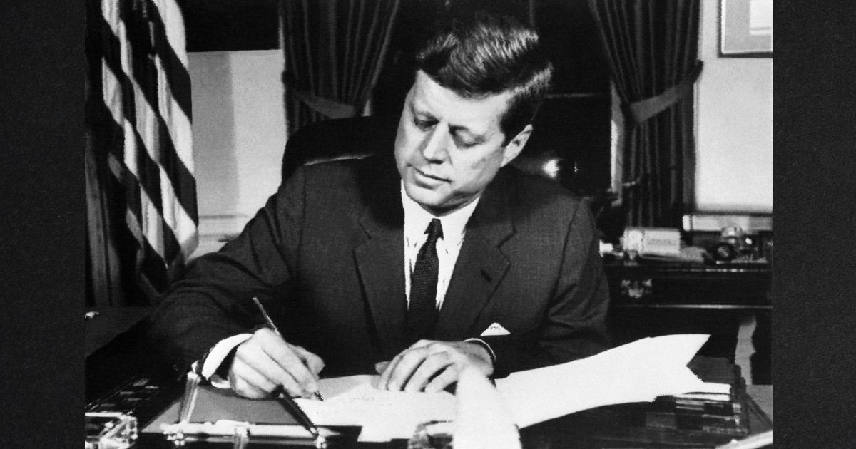 President John F. Kennedy signs the order of a naval blockade of Cuba, on October 23, 1962 in White House, Washington D.C, during the Cuban missile crisis.