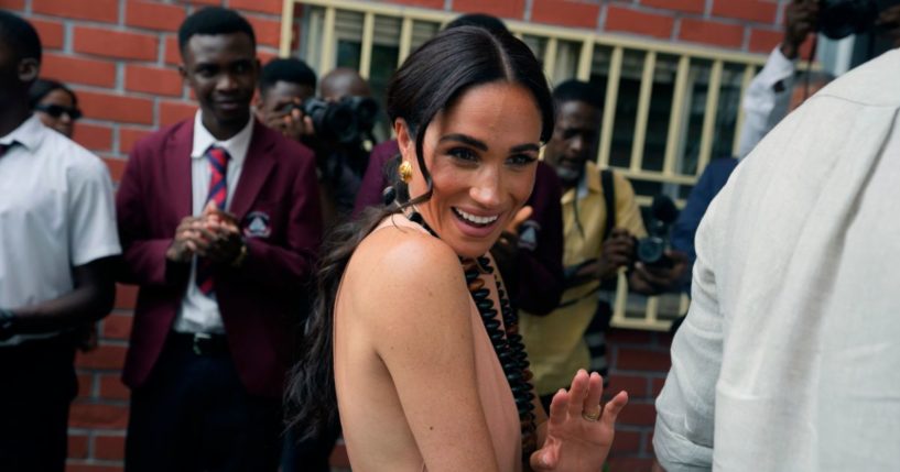 Meghan gestures as she and Prince Harry visit the Lights Academy in Abuja, Nigeria, on May 10.