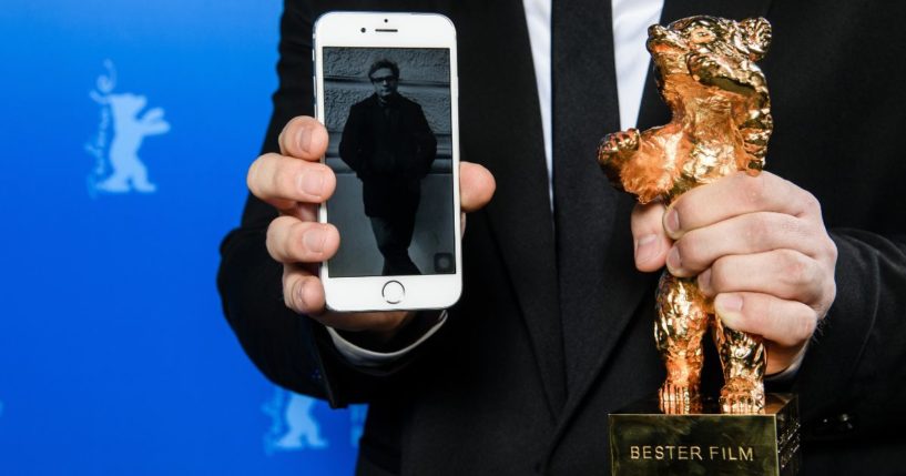 An image of Iranian director Mohammad Rasoulof, winner of the Golden Bear for Best Film for the film "There Is No Evil," is shown next to his award at the award winners news conference during the 70th Berlinale International Film Festival Berlin in Berlin, Germany, on Feb. 29, 2020.