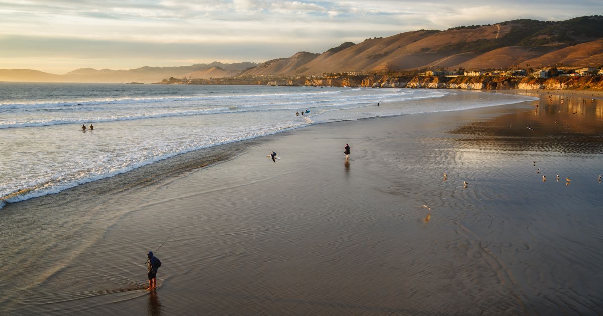 A stock photo shows people enjoying the sunset at Pismo Beach, California, on Jan. 1, 2021.