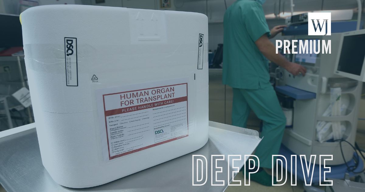 A styrofoam box used for transporting human organs sits on a cart in an operation room as a DSO employee stands nearby at the Vivantes Neukoelln clinic in Berlin, Germany, on Sept. 28, 2012.