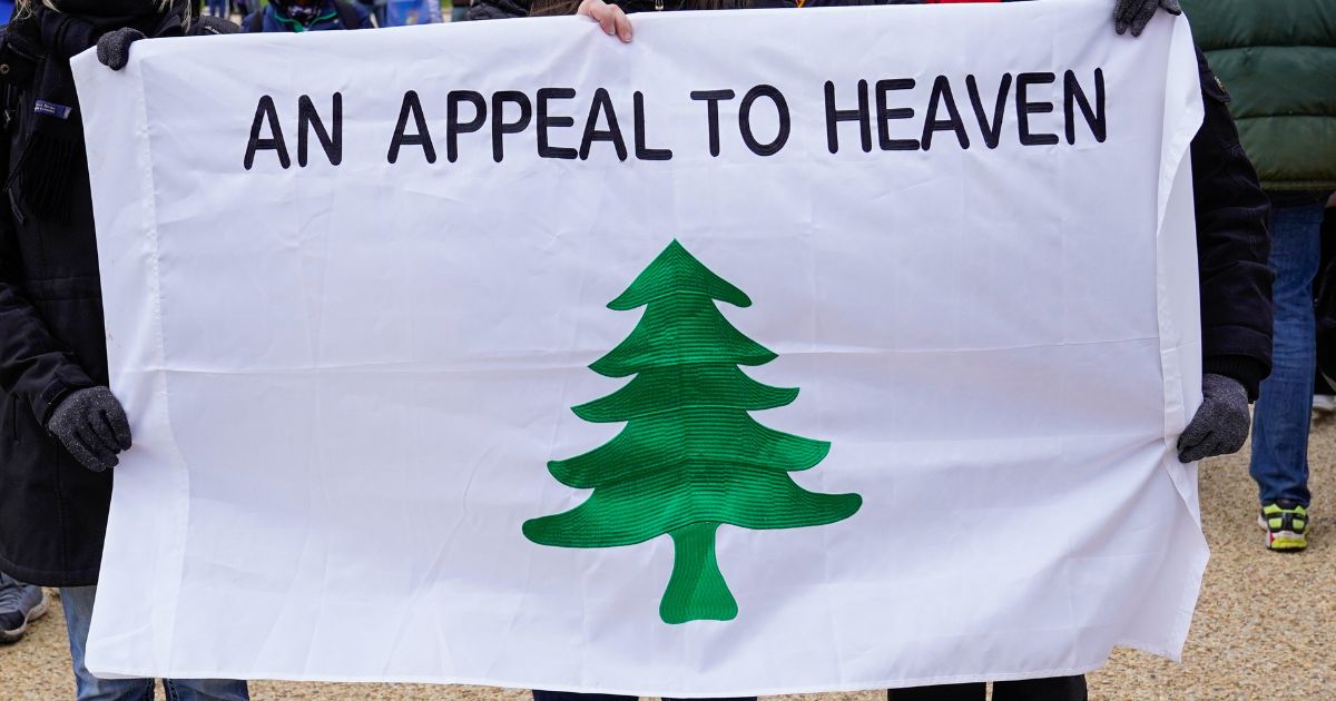 Crowds gather for the "Stop the Steal" rally carrying an "Appeal to Heaven" flag on January 6, 2021 in Washington, DC.