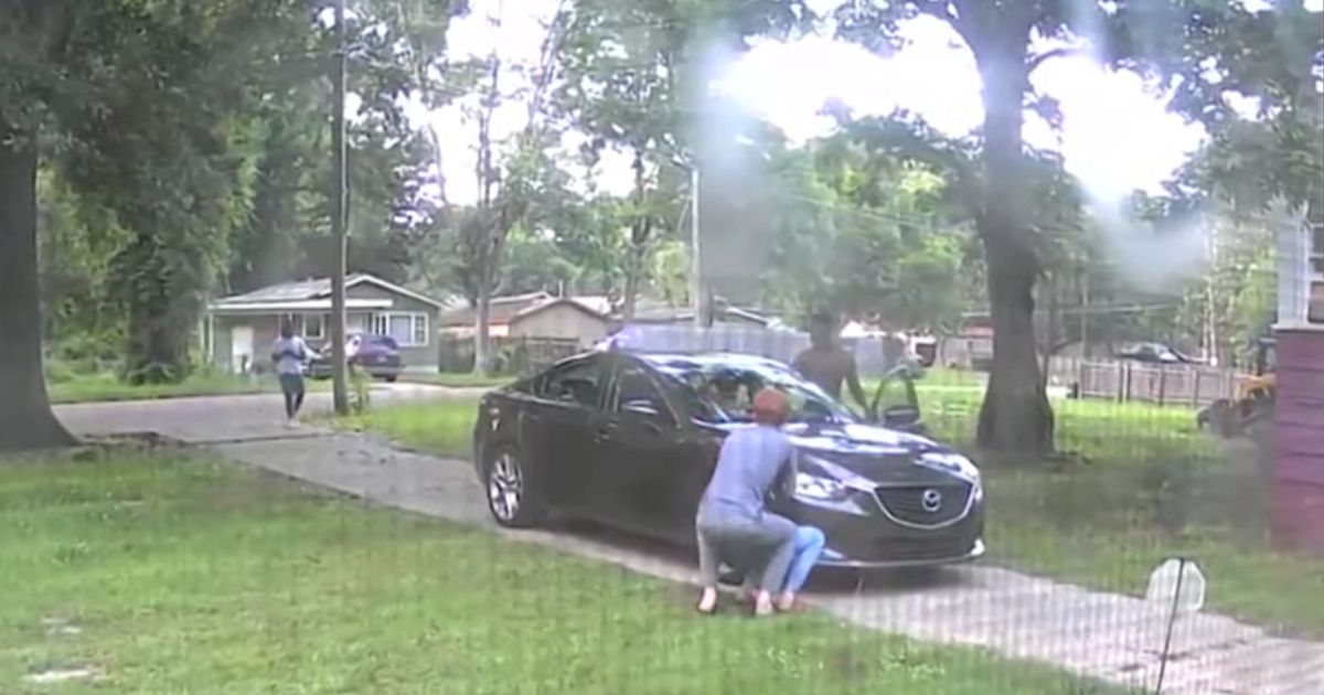 surveillance footage of two men attempting to steal a car from a family