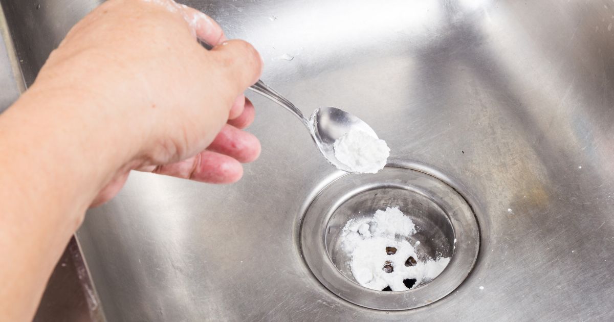 This Getty stock image shows baking soda being used to unclog a drain.