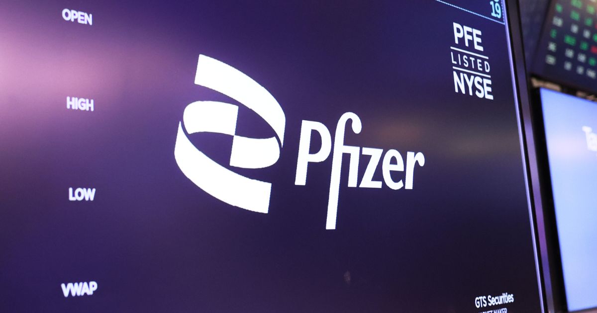 The Pfizer company logo is displayed as traders work on the floor of the New York Stock Exchange during morning trading on April 10, 2023 in New York City.