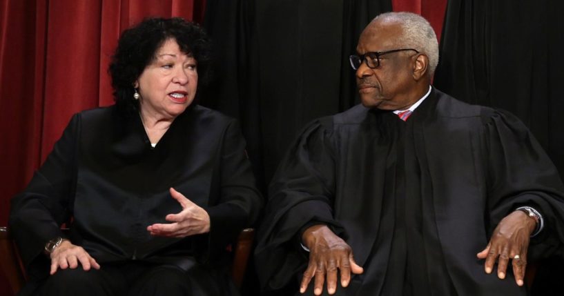 United States Supreme Court Associate Justice Sonia Sotomayor (L) and Associate Justice Clarence Thomas (R) pose for their official portrait at the East Conference Room of the Supreme Court building on October 7, 2022 in Washington, DC.