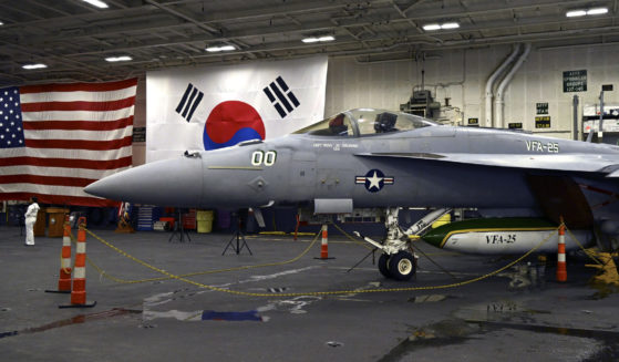 An F-18 fighter aircraft sits in the hanger of the Theodore Roosevelt (CVN 71), a nuclear-powered aircraft carrier anchored in Busan Naval Base in Busan, South Korea Saturday, June 22, 2024.