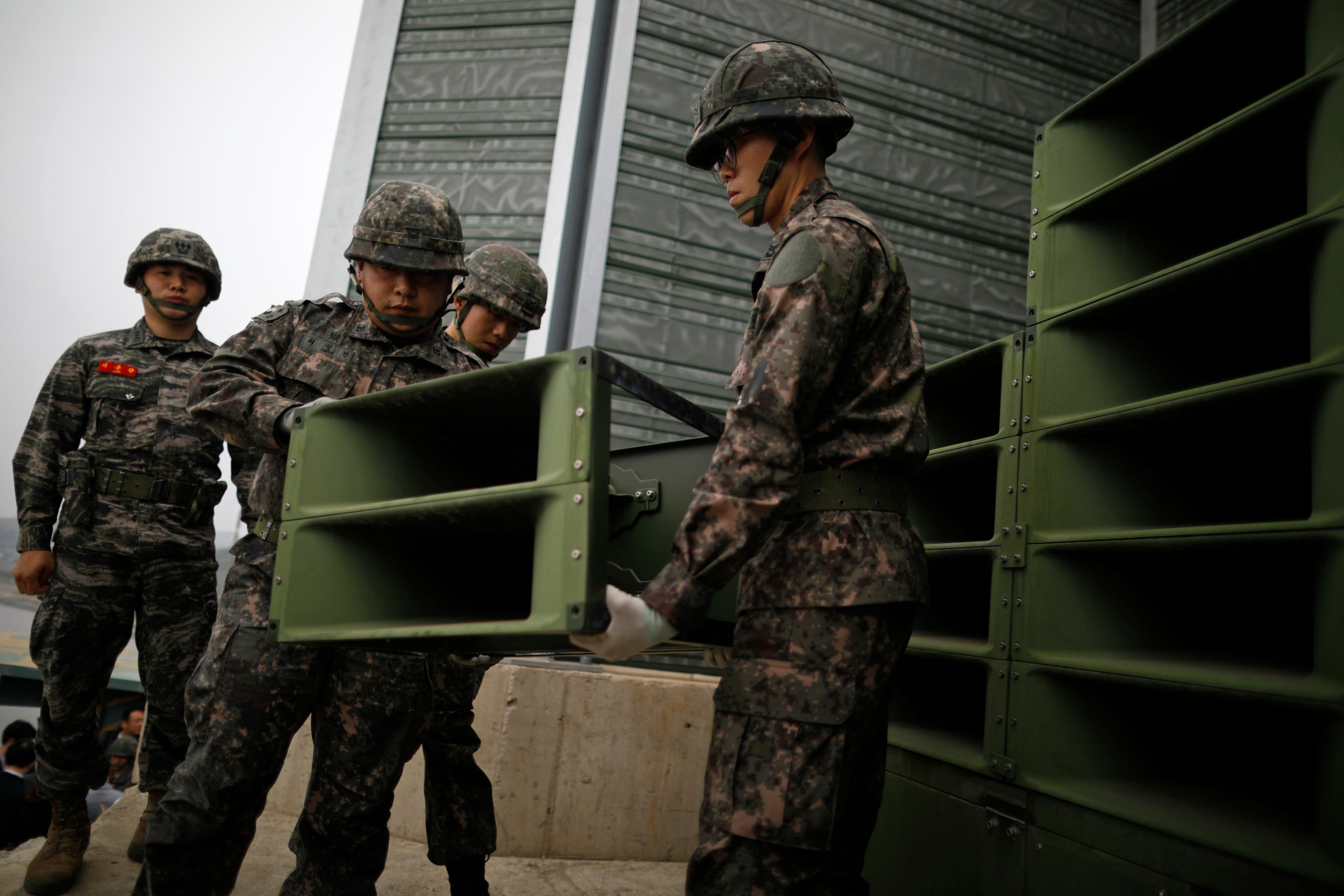 South Korean soldiers dismantle loudspeakers that were set up for propaganda broadcasts near the demilitarized zone separating the two Koreas in Paju, South Korea, on May 1, 2018.