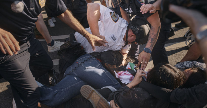 A New York City police officer subdues a pro-Palestinian protester as he pins him on the ground during a protest on May 31, 2024, in the Brooklyn borough of New York.