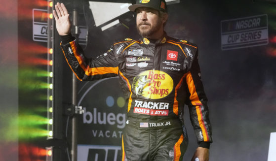 Martin Truex Jr. waves to fans before Daytona 500 qualifying auto races at Daytona International Speedway, Feb. 15, 2024, in Daytona Beach, Florida. Truex announced his retirement from full-time racing Friday, saying it was time to live by his own schedule after 19 full-time seasons as a NASCAR Cup Series driver.
