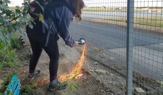 Radical climate activists cut through an airport fence in Britain.