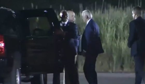 President Joe Biden approaches the presidential SUV.