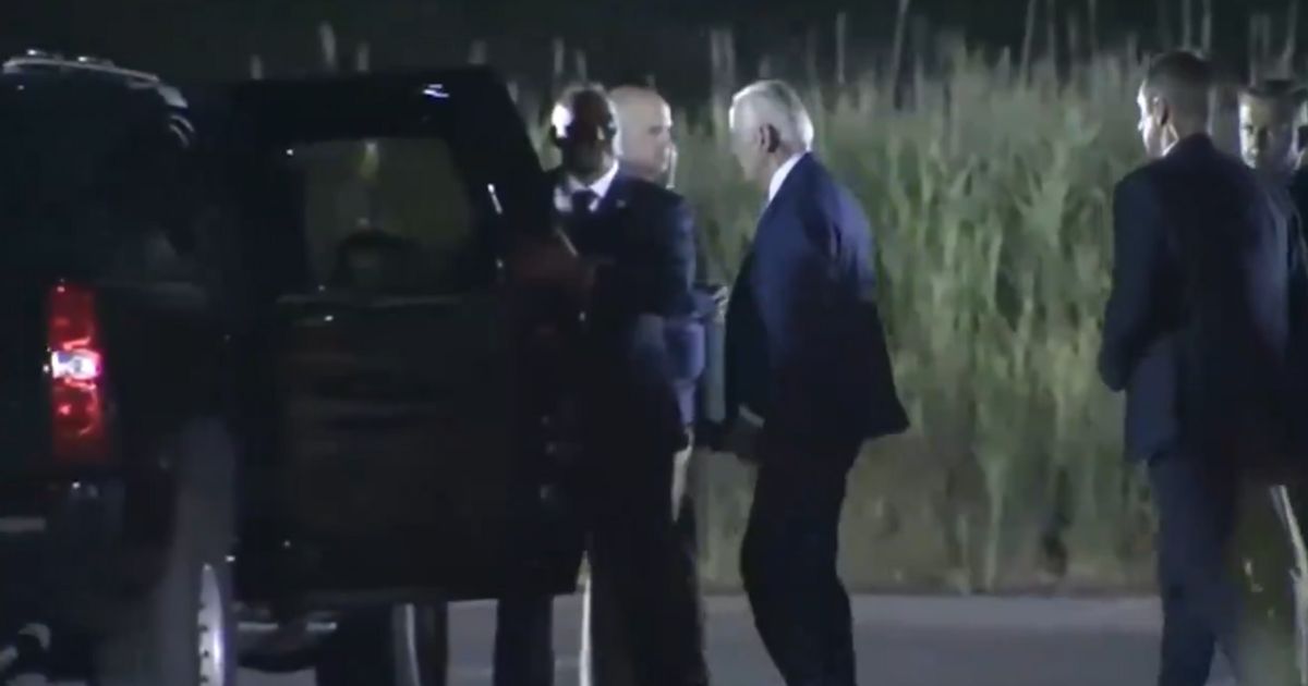 President Joe Biden approaches the presidential SUV.