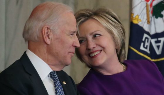 In a file photo from 2016, Hillary Clinton, right, shares a laugh with then-Vice President Joseph Biden. A Washington Post columnist has floated the idea of Biden ditching Kamala Harris for Clinton to be a more popular running mate for 2024.