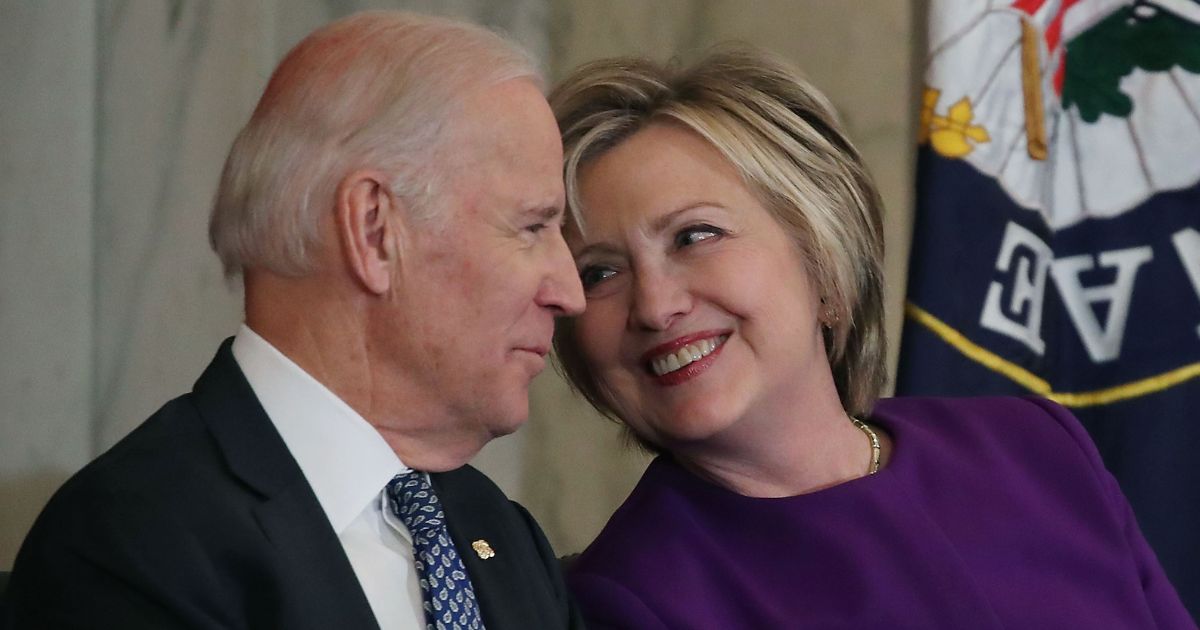 In a file photo from 2016, Hillary Clinton, right, shares a laugh with then-Vice President Joseph Biden. A Washington Post columnist has floated the idea of Biden ditching Kamala Harris for Clinton to be a more popular running mate for 2024.