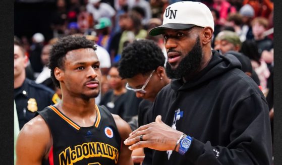 Bronny James, left, talks to his dad, Lebron James of the Los Angeles Lakers, after the 2023 McDonald's High School Boys All-American Game on March 28, 2023 in Houston, Texas.