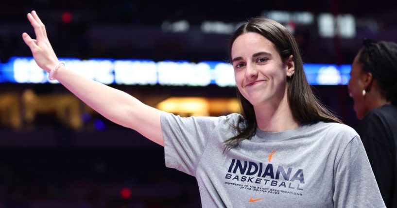 Caitlin Clark of the Indiana Fever waves during the U.S. Olympic Team Swimming Trials at Lucas Oil Stadium in Indianapolis on Tuesday.