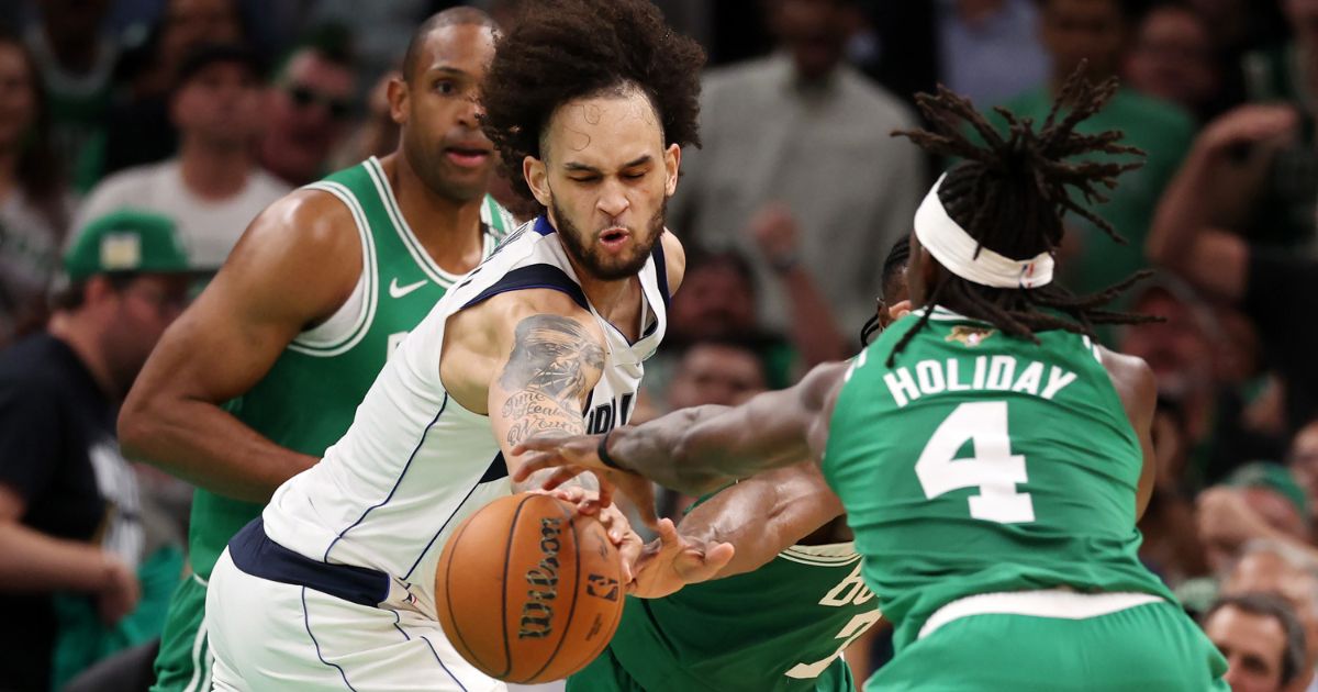 Jrue Holiday of the Boston Celtics attempts to steal the ball from Dereck Lively II of the Dallas Mavericks during the second quarter of Game 5 of the NBA Finals at TD Garden in Boston on Monday.