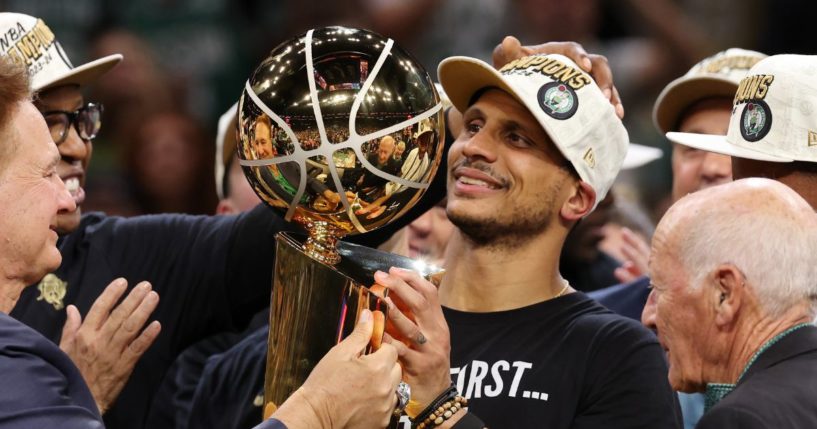 Head coach Joe Mazzulla of the Boston Celtics lifts the Larry O’Brien Championship Trophy after Boston's 106-88 win against the Dallas Mavericks in Game Five of the NBA Finals at TD Garden in Boston on Monday.