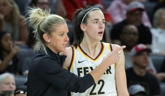 Indiana Fever coach Christie Sides talks to star rookie Caitlin Clark during a game against the Las Vegas Aces at Michelob Ultra Arena in Las Vegas on May 25.