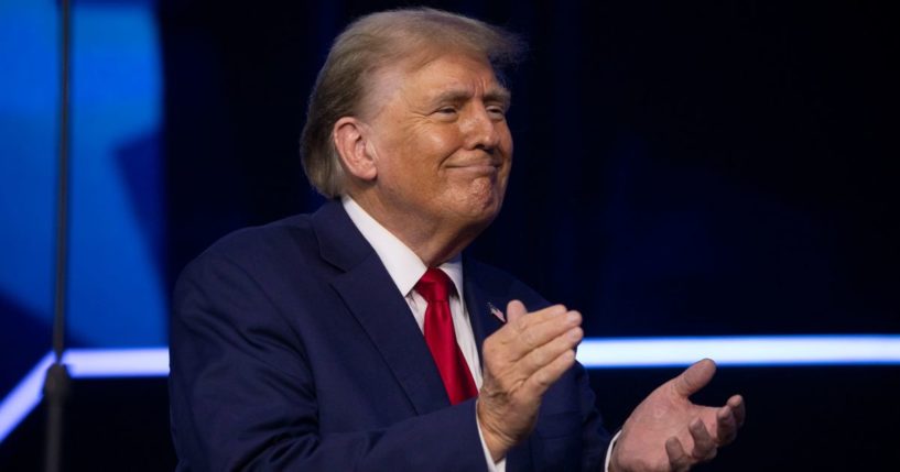 Former President Donald Trump walks on stage to give the keynote address at Turning Point Action's "The People's Convention" in Detroit on Saturday.