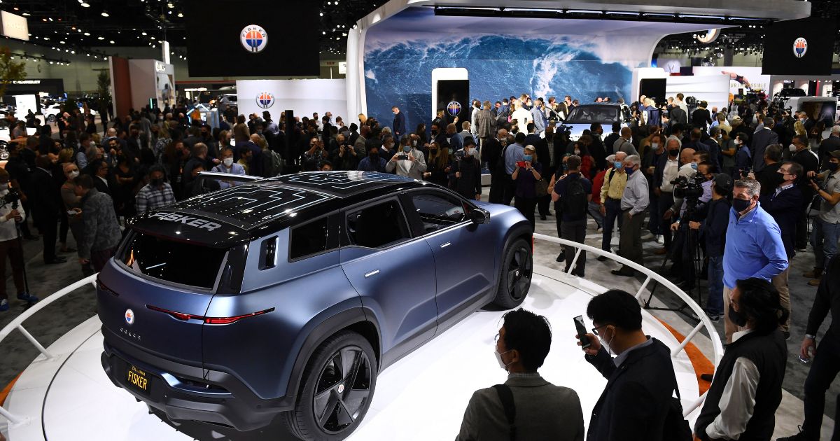 Attendees view the Fisker Ocean electric vehicle after its unveiling during AutoMobility LA ahead of the Los Angeles Auto Show on Nov. 17, 2021.