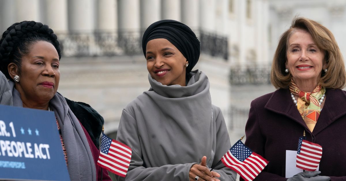 Reps. Sheila Jackson Lee, left, Ilhan Omar, center, and then-House Speaker Nancy Pelosi, right, celebrate 100 days of Democrats taking a majority in the house outside the Capitol in Washington, D.C., on March 8, 2019.