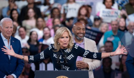 First lady Jill Biden, with "VOTE" printed on her dress, speaks at a post-debate campaign rally on Friday in Raleigh, North Carolina, as her husband, President Joe Biden looks on.