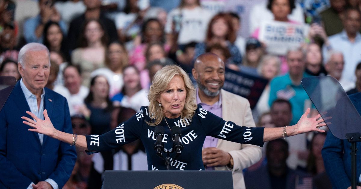 First lady Jill Biden, with "VOTE" printed on her dress, speaks at a post-debate campaign rally on Friday in Raleigh, North Carolina, as her husband, President Joe Biden looks on.