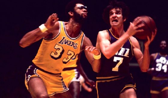 The late “Pistol” Pete Maravich of the New Orleans Jazz drives to the basket while being guarded by the Los Angeles Lakers' Kareem Abdul-Jabbar game on the Lakers home court of The Forum on February 13, 1976.