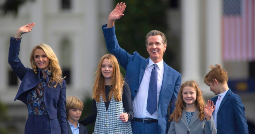 Gov. Gavin Newsom waves with his wife, Jennifer Siebel Newsom, and children Dutch, Montana, Brooklynn, and Hunter following his inauguration in Sacramento, California, on Jan. 6, 2023.