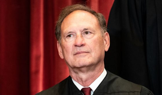 Associate Justice Samuel Alito sits during a group photo of the Justices at the Supreme Court.