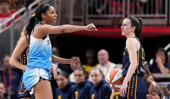 Angel Reese of the Chicago Sky, left, reacts after fouling Caitlin Clark of the Indiana Fever, right, during the second half of a WNBA game at Gainbridge Fieldhouse in Indianapolis on Sunday.