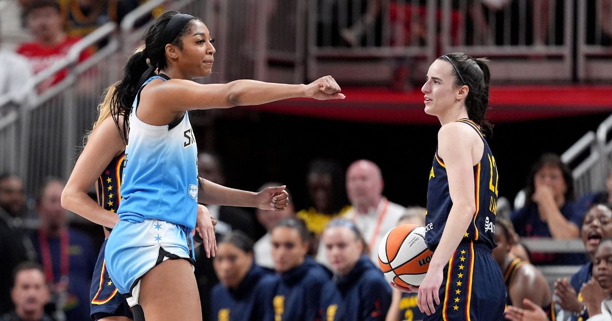 Angel Reese of the Chicago Sky, left, reacts after fouling Caitlin Clark of the Indiana Fever, right, during the second half of a WNBA game at Gainbridge Fieldhouse in Indianapolis on Sunday.