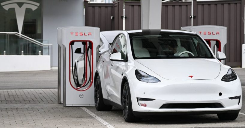 A Tesla electric vehicle charges at a Tesla Supercharger location in Santa Monica, California, on May 15.