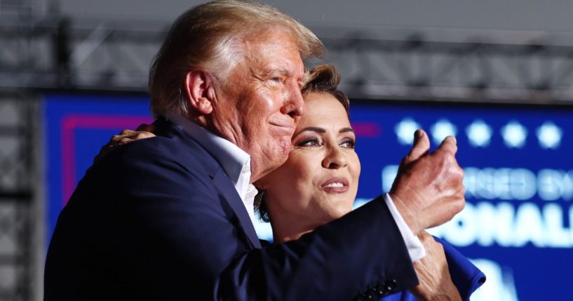 Former President Donald Trump embraces Arizona Republican Kari Lake at a campaign rally at Legacy Sports USA in Mesa, Arizona, on Oct. 9, 2022.