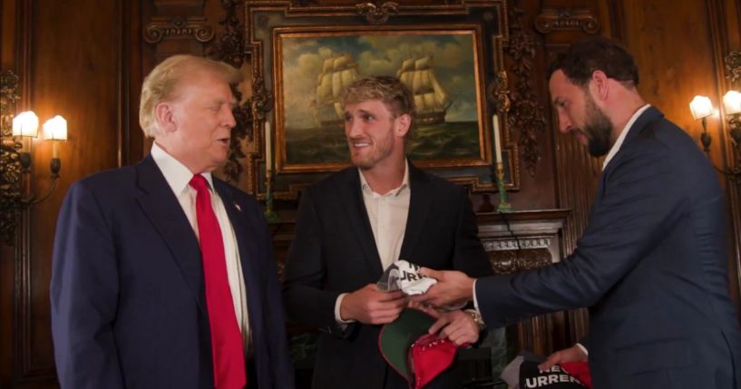 Before doing an interview on Logan Paul's, center, "Impaulsive" podcast, former President Donald Trump, left, gave Paul a gift.