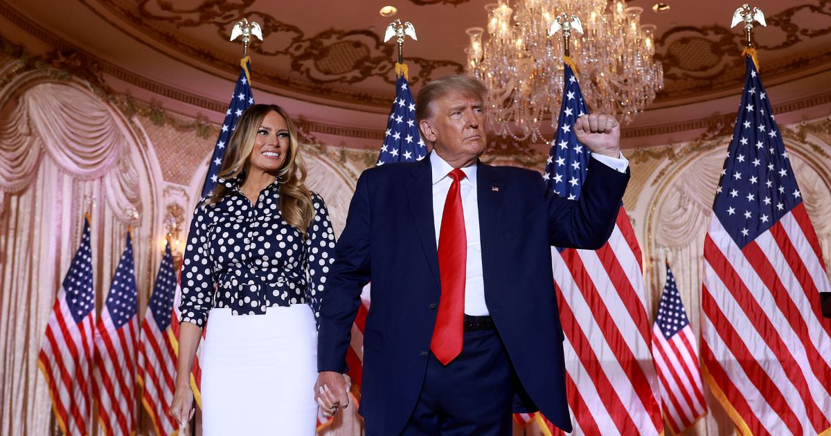 Former U.S. President Donald Trump and former first lady Melania Trump stand together during an event at his Mar-a-Lago home on November 15, 2022 in Palm Beach, Florida.