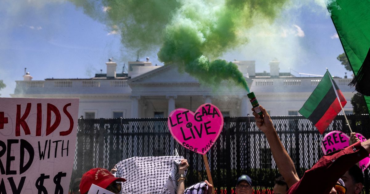 Pro-Palestinian activists set off smoke bombs on Pennsylvania Avenue in front of the White House during a demonstration protesting the war in Gaza on June 8, 2024, in Washington, D.C.